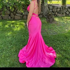 Stunning gown with open back. Light weight true to size.